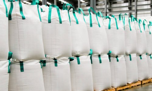 Huge sacks of sugar in a warehouse.